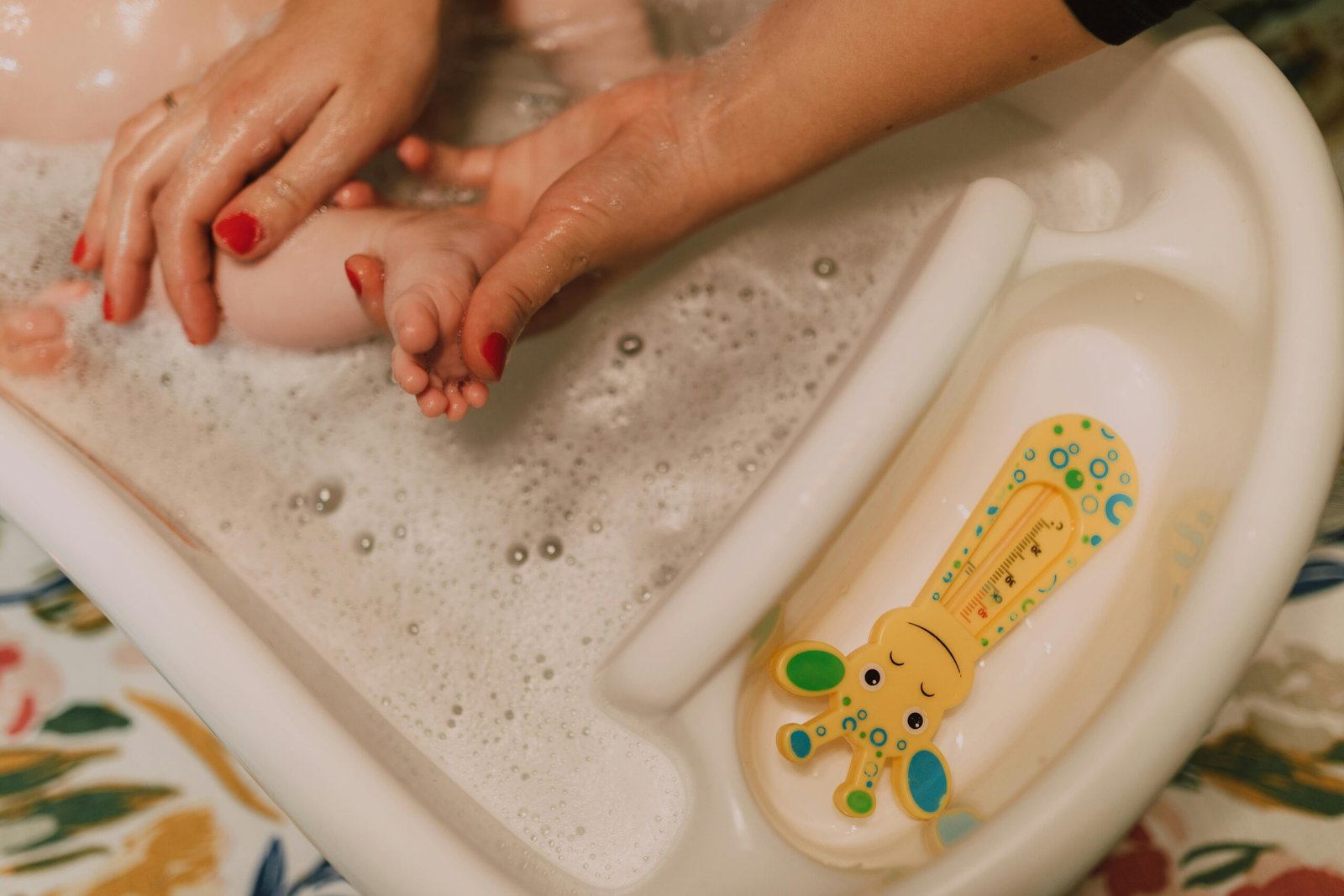 A caring parent gently bathes a baby in a bubbly bathroom scene, showcasing love and hygiene.